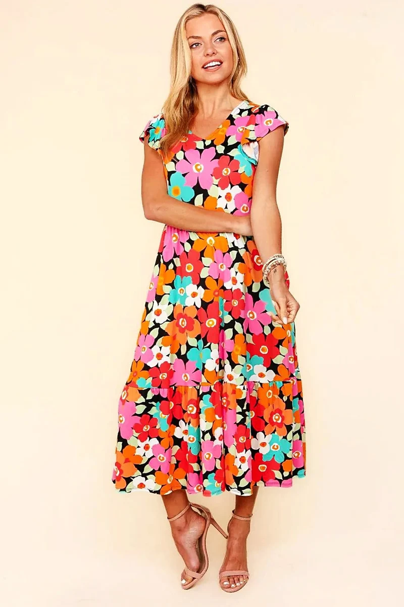 Elegante midi-jurk met bloemenprint en zakken – perfect voor casual of feestelijke gelegenheden in de lente en zomer.