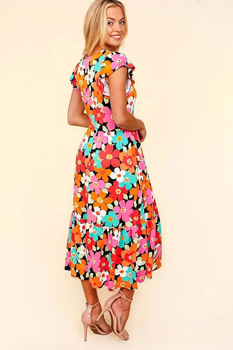 Elegante midi-jurk met bloemenprint en zakken – perfect voor casual of feestelijke gelegenheden in de lente en zomer.
