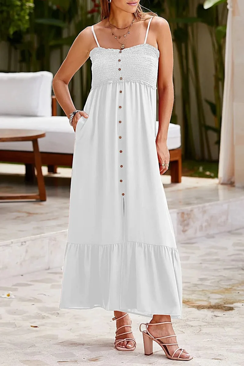 Elegante zomerjurk met spaghettibandjes, ruches aan de zoom en decoratieve knoopjes, met smockwerk.