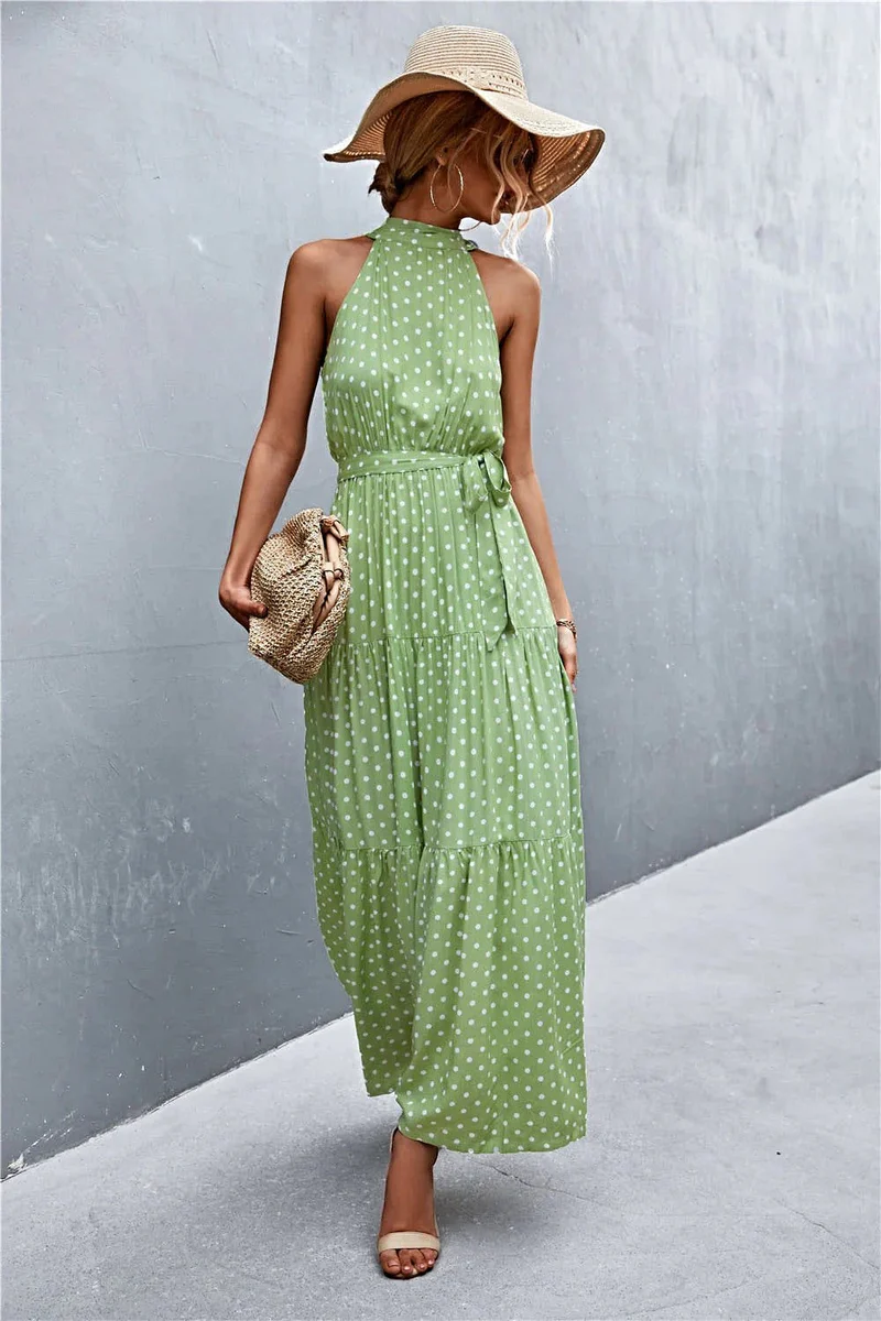 Griekse maxi-jurk met print, strikceintuur, mouwloos ontwerp en stippenpatroon.