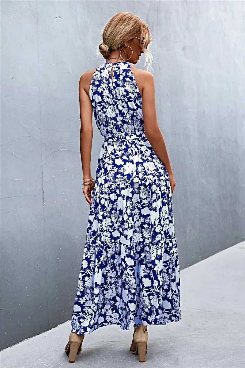 Griekse maxi-jurk met print, strikceintuur, mouwloos ontwerp en stippenpatroon.