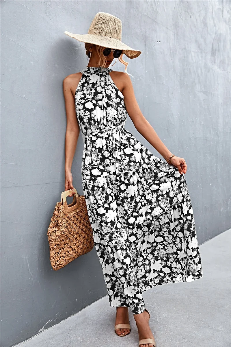 Griekse maxi-jurk met print, strikceintuur, mouwloos ontwerp en stippenpatroon.