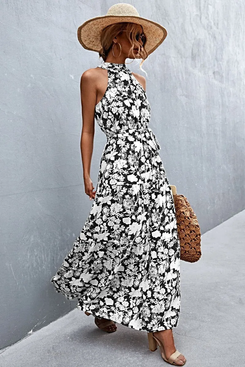 Griekse maxi-jurk met print, strikceintuur, mouwloos ontwerp en stippenpatroon.