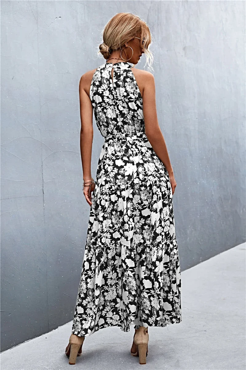 Griekse maxi-jurk met print, strikceintuur, mouwloos ontwerp en stippenpatroon.