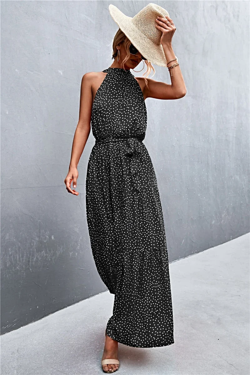 Griekse maxi-jurk met print, strikceintuur, mouwloos ontwerp en stippenpatroon.