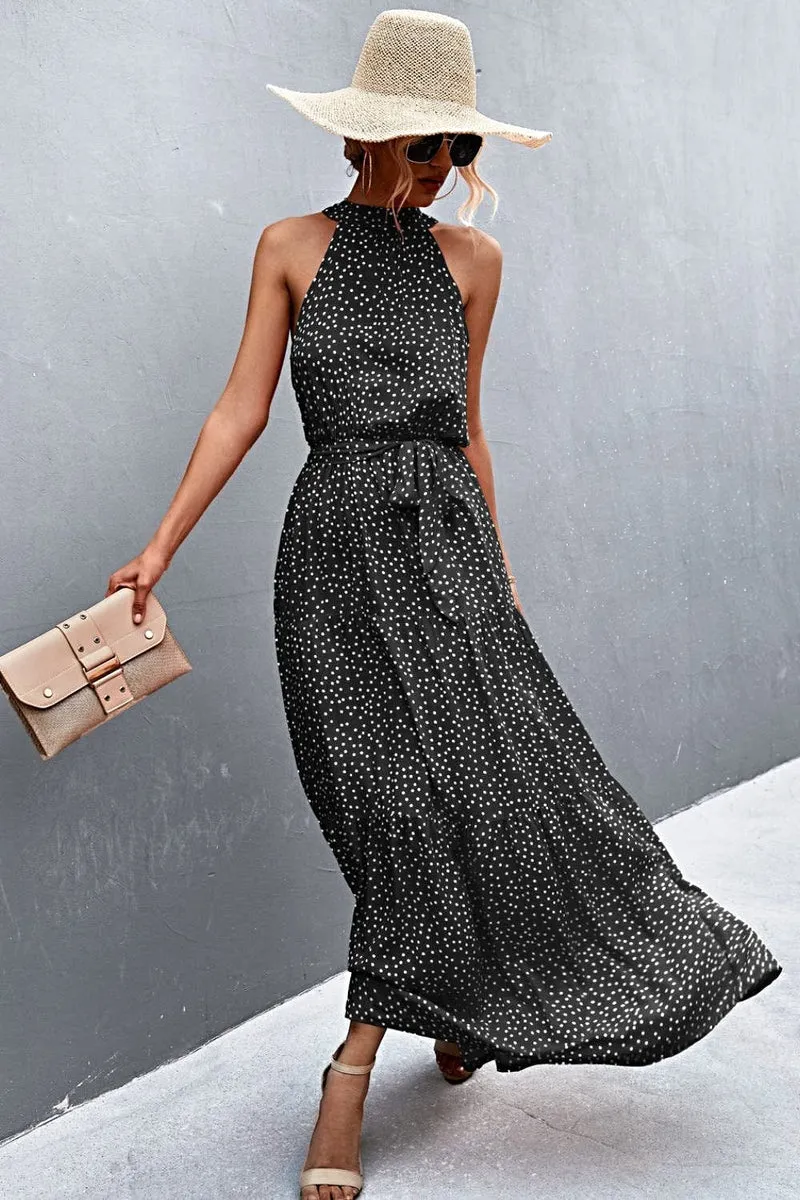Griekse maxi-jurk met print, strikceintuur, mouwloos ontwerp en stippenpatroon.