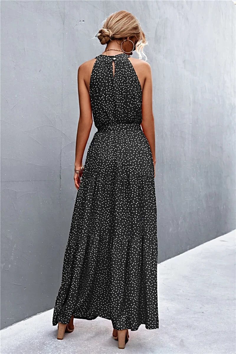 Griekse maxi-jurk met print, strikceintuur, mouwloos ontwerp en stippenpatroon.
