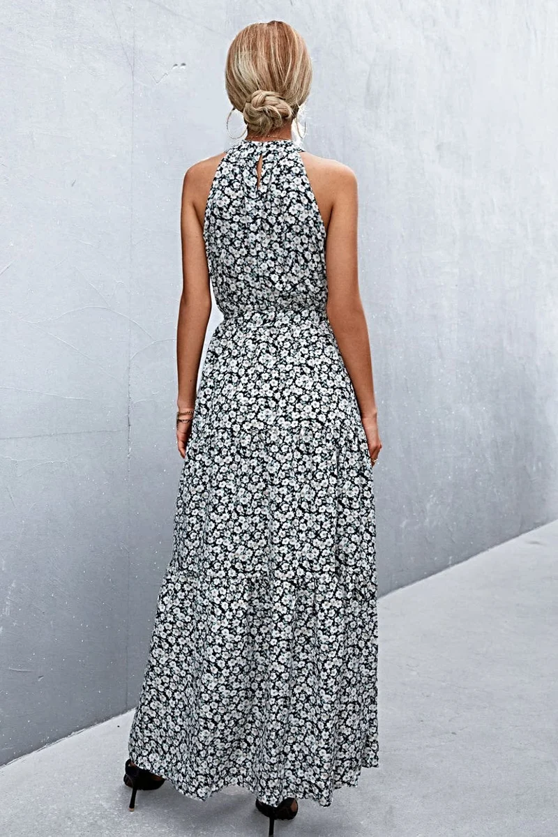Griekse maxi-jurk met print, strikceintuur, mouwloos ontwerp en stippenpatroon.