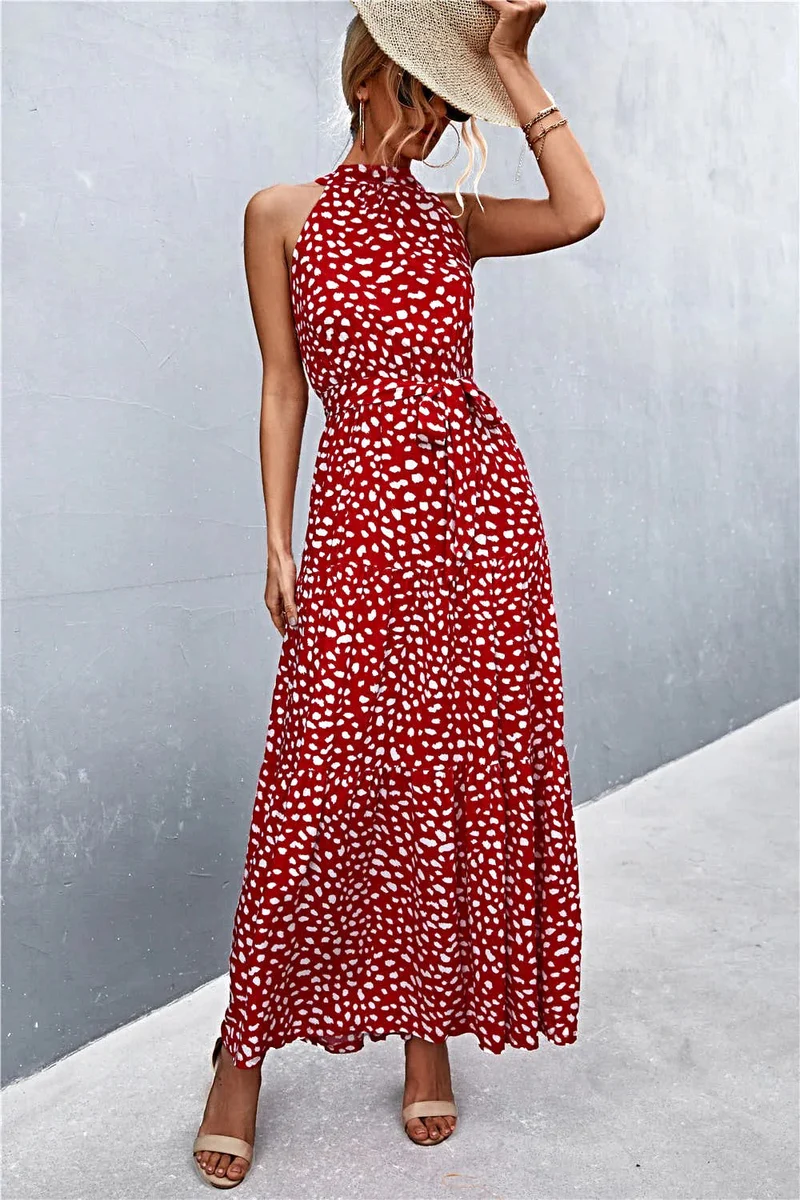 Griekse maxi-jurk met print, strikceintuur, mouwloos ontwerp en stippenpatroon.