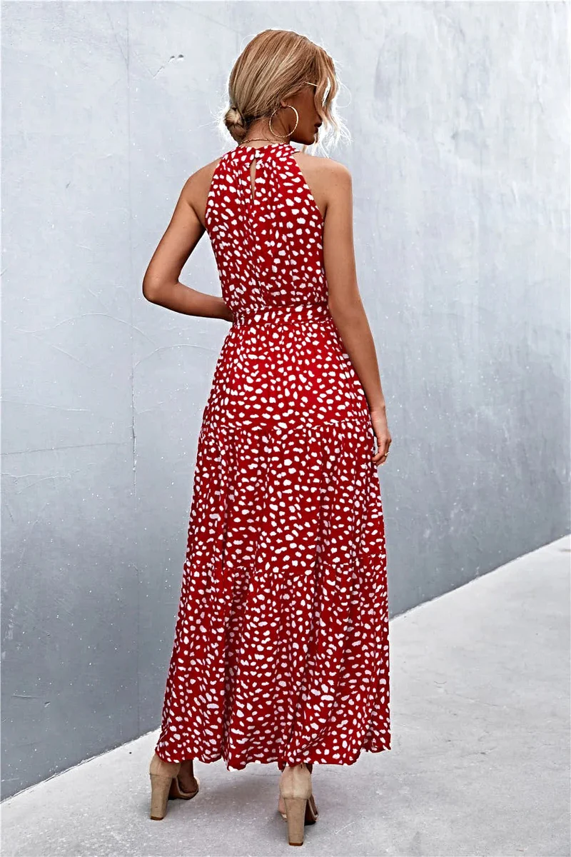 Griekse maxi-jurk met print, strikceintuur, mouwloos ontwerp en stippenpatroon.