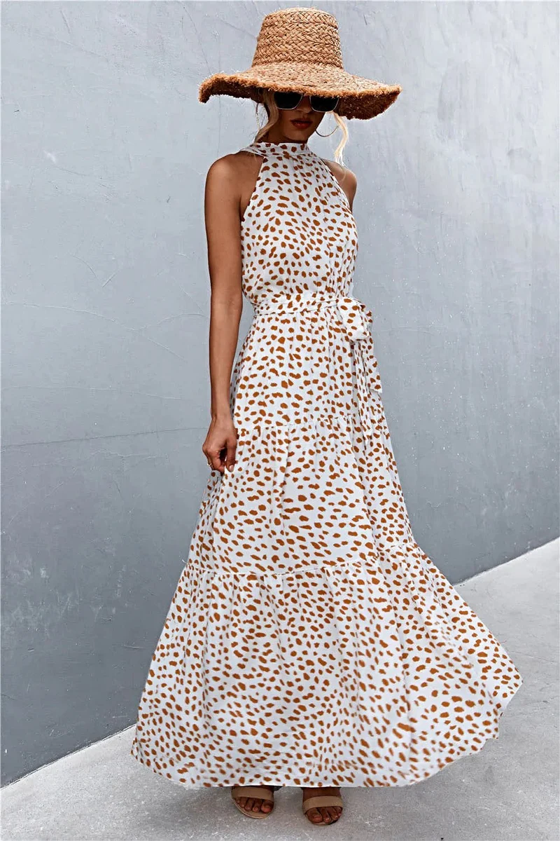 Griekse maxi-jurk met print, strikceintuur, mouwloos ontwerp en stippenpatroon.