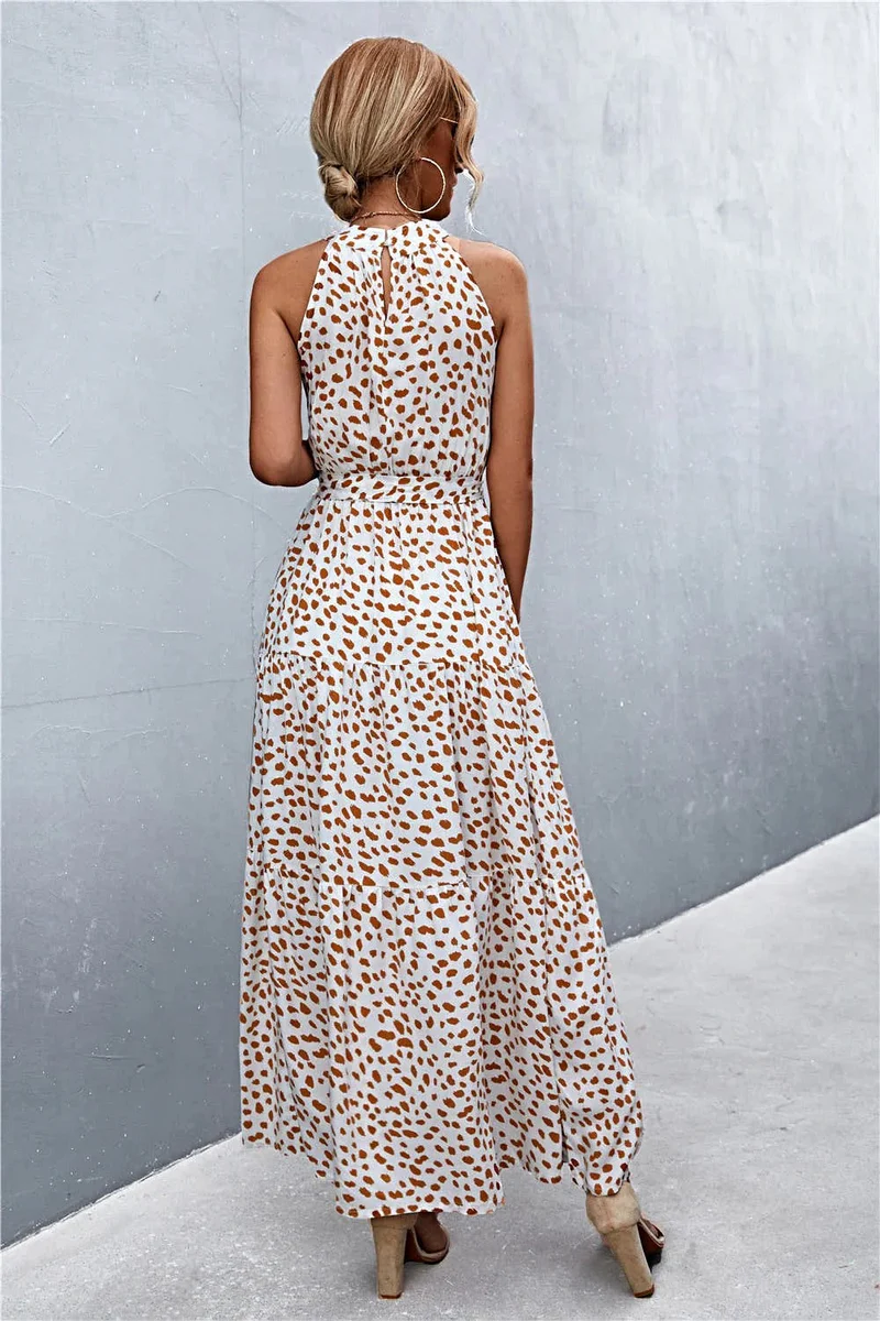 Griekse maxi-jurk met print, strikceintuur, mouwloos ontwerp en stippenpatroon.