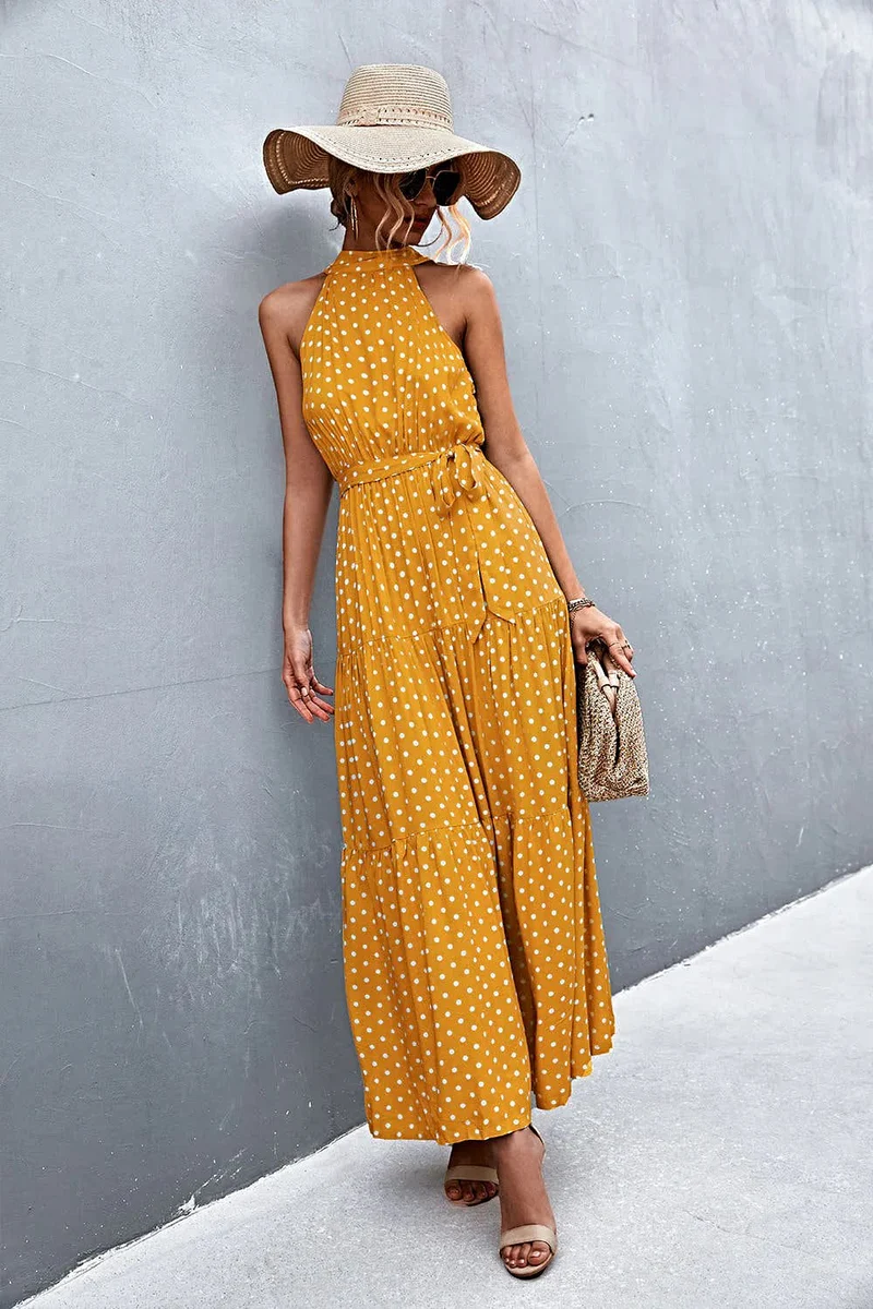 Griekse maxi-jurk met print, strikceintuur, mouwloos ontwerp en stippenpatroon.