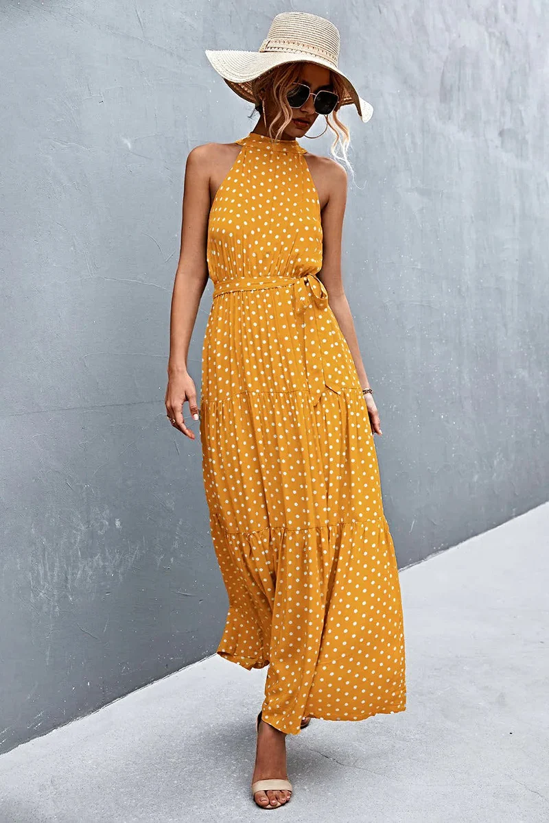 Griekse maxi-jurk met print, strikceintuur, mouwloos ontwerp en stippenpatroon.