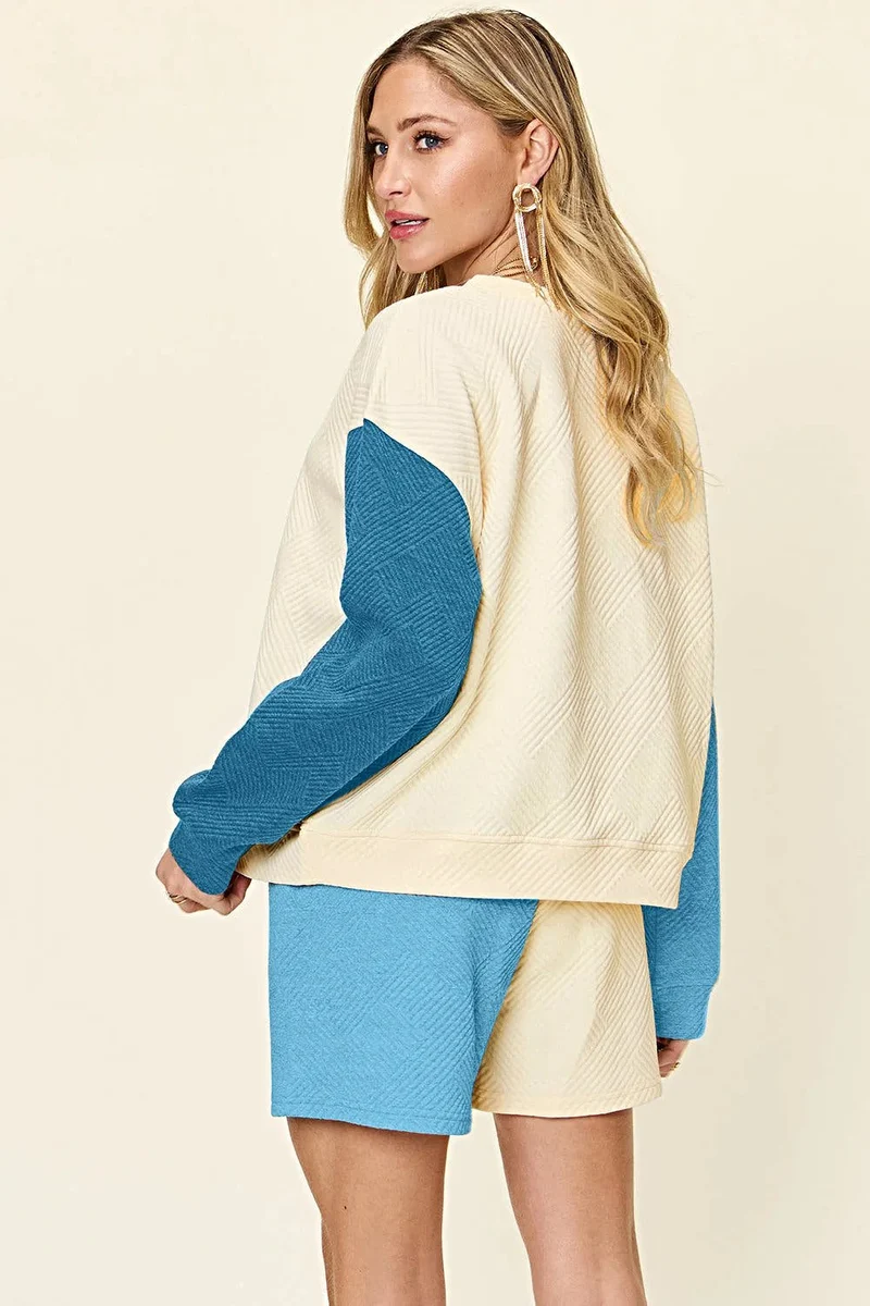 Luxe tweedelige set met short, zakken en top met verlaagde schouders.