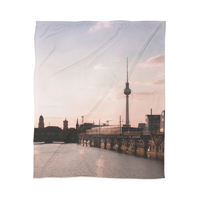 Berlin Germany I Fernsehturm television tower and Spree river at sunset in a pastel pink sky Throw Blanket