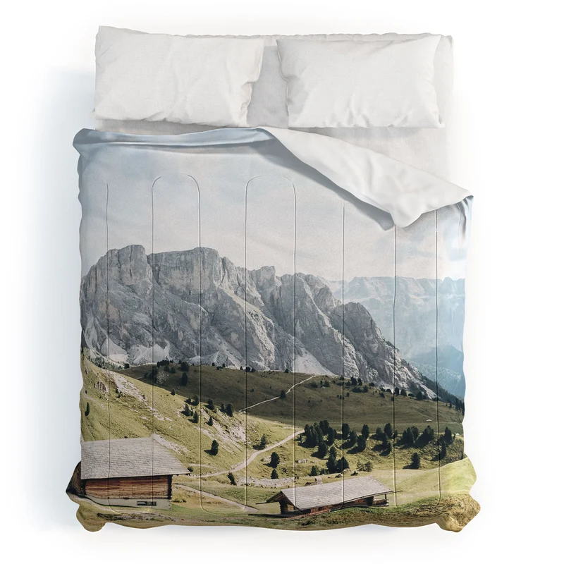 Dolomites Italy I Wooden chalets on the Seceda alpine meadow in the mountain of the Italian Alps Comforter