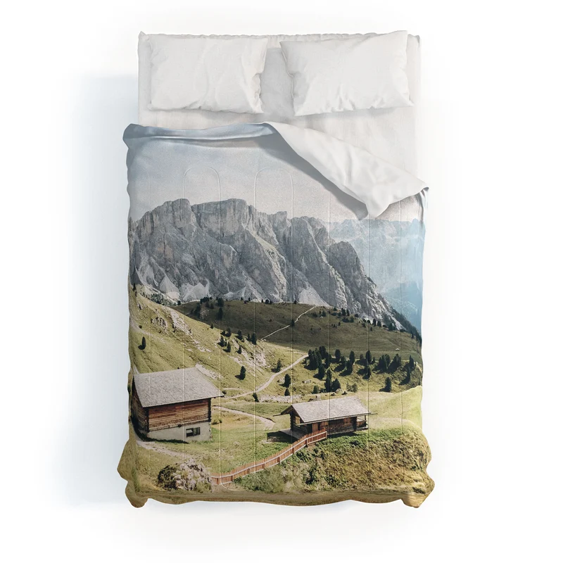 Dolomites Italy I Wooden chalets on the Seceda alpine meadow in the mountain of the Italian Alps Comforter