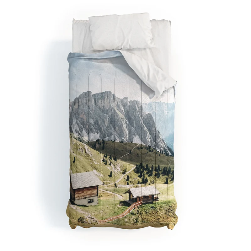 Dolomites Italy I Wooden chalets on the Seceda alpine meadow in the mountain of the Italian Alps Comforter