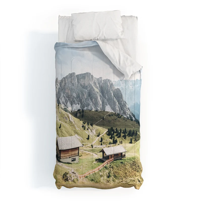 Dolomites Italy I Wooden chalets on the Seceda alpine meadow in the mountain of the Italian Alps Comforter