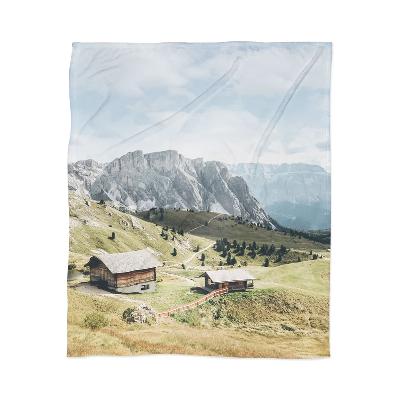 Dolomites Italy I Wooden chalets on the Seceda alpine meadow in the mountain of the Italian Alps Throw Blanket