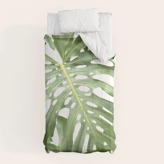 Vibrant tropical foliage on white Comforter